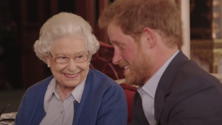 Queen Elizabeth smiling with Prince Harry