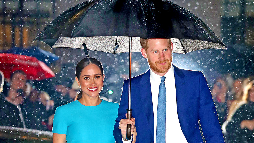 Meghan Markle with Prince Harry in the rain