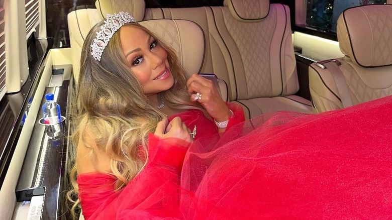 Mariah Carey wearing a tiara, posing