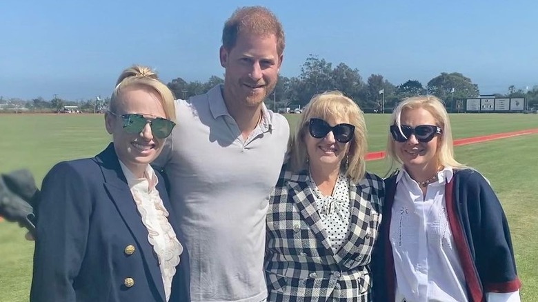 Prince Harry posing with Rebel Wilson, her mother, and Ramona Agruma