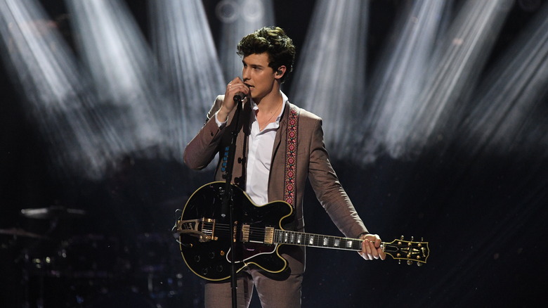 Shawn Mendes with guitar, performing