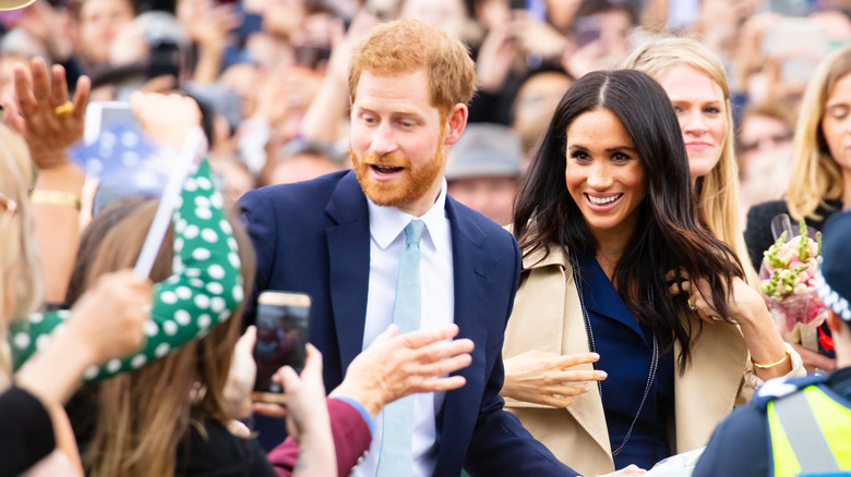 Prince Harry and Meghan Markle greeting crowd