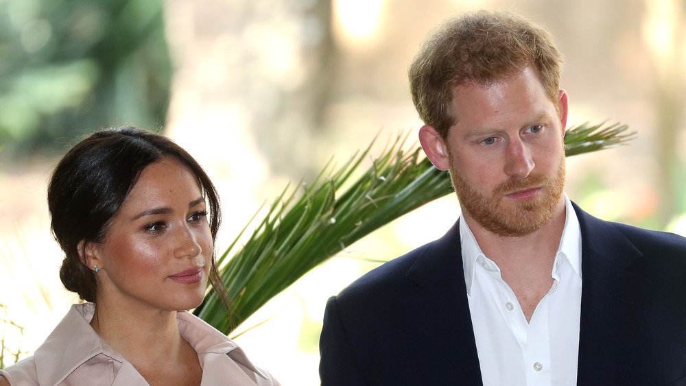 Meghan Markle and Prince Harry listening intently 