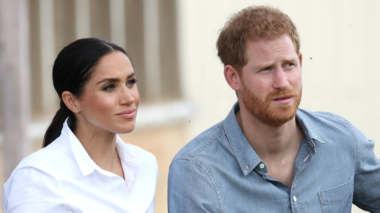 Meghan Markle and Prince Harry sit together