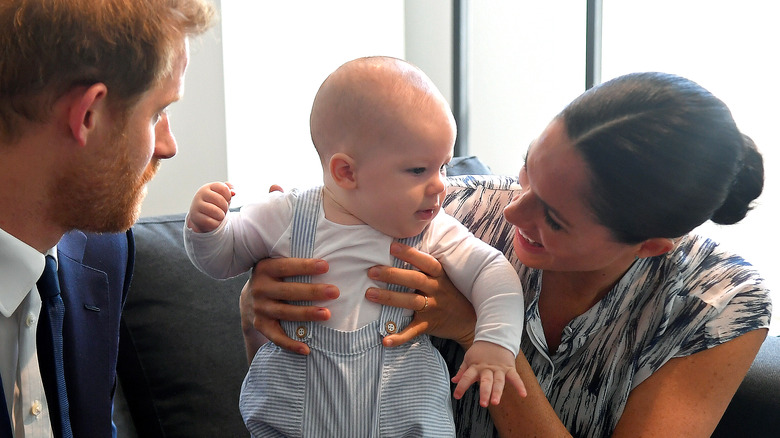 Prince Harry and Meghan Markle hold son 