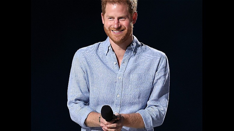 Prince Harry smiling on stage