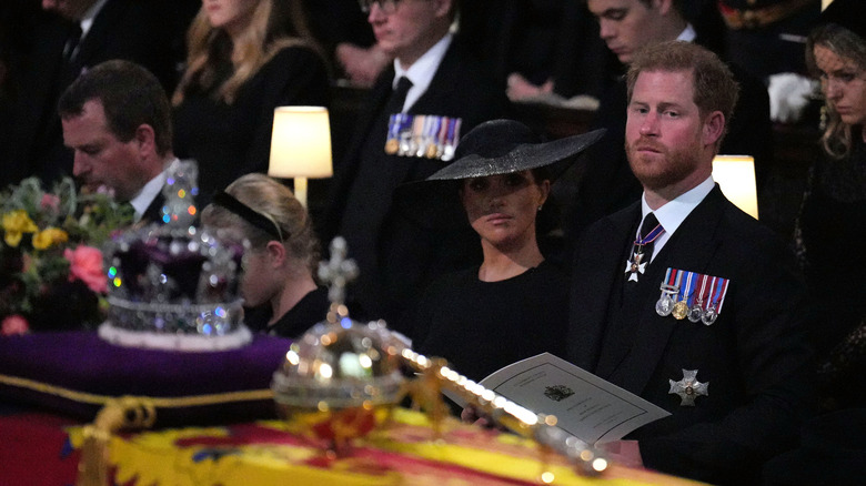 Meghan and Harry looking at Queen Elizabeth's casket