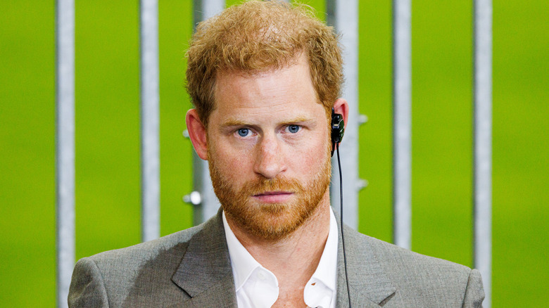 Prince Harry with listening device in ear