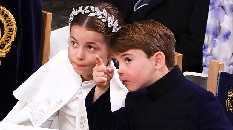 Prince Louis pointing next to Princess Charlotte