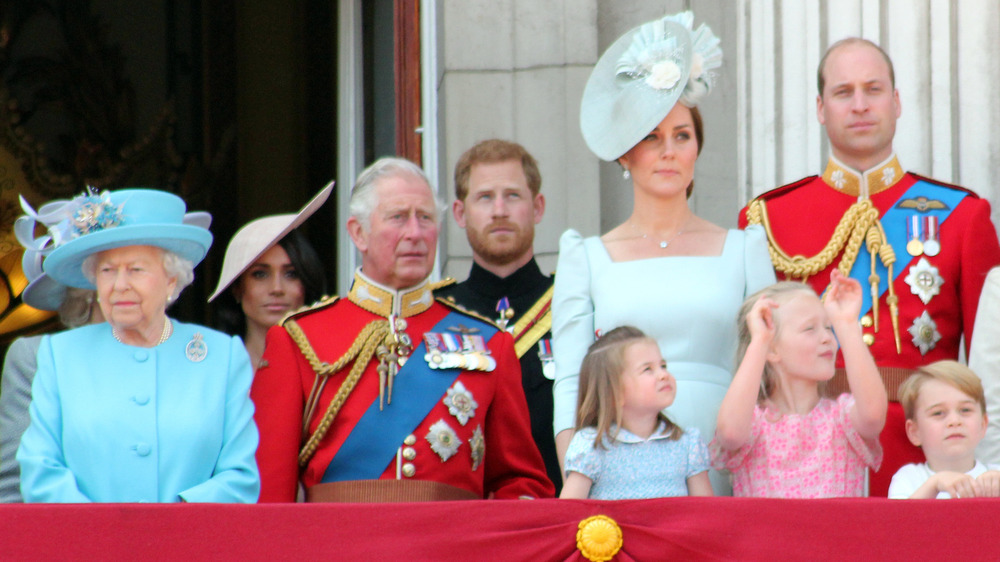 The royal family standing on a balcony