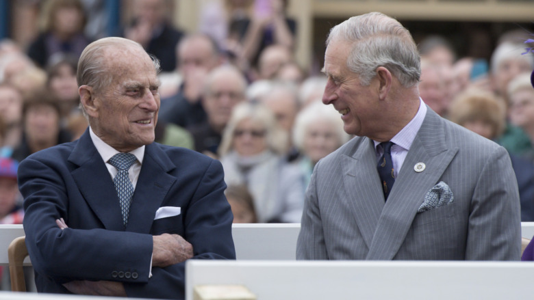 Prince Philip speaking with Prince Charles