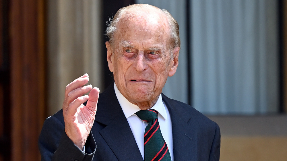 Prince Philip waving with a grimace