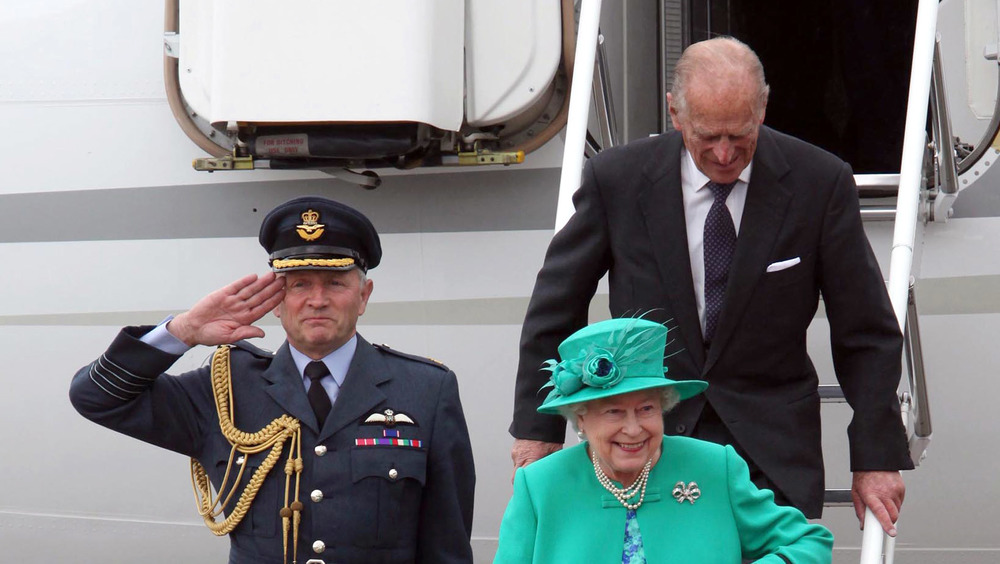 Queen Elizabeth and Prince Philip disembarking from airplane