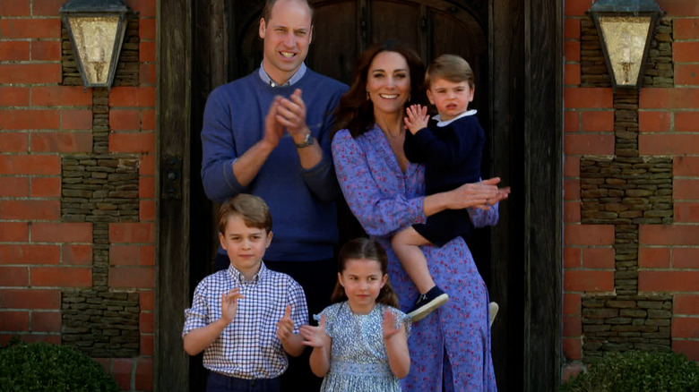 The Cambridge family smiles at a royal engagement