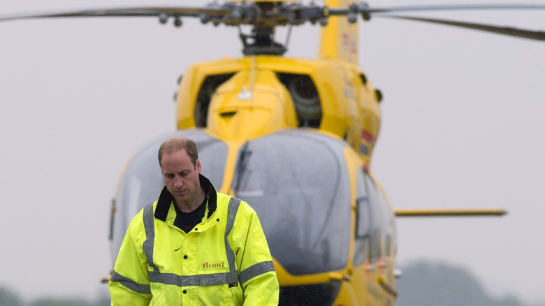 Prince William walks ahead of his 'Air Ambulance' helicopter