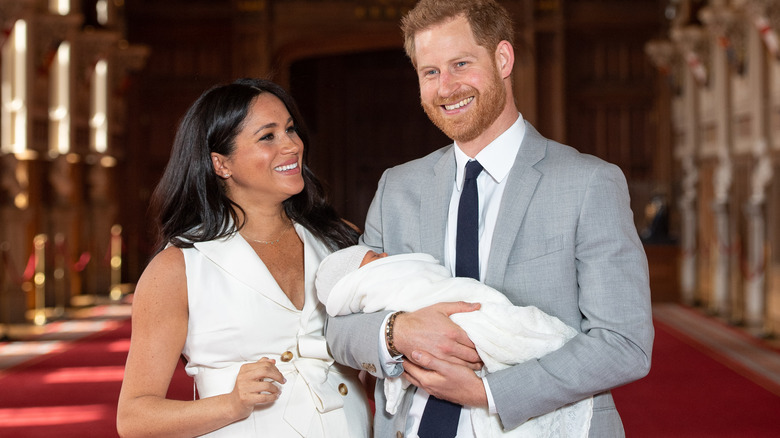 Meghan and Harry holding Archie