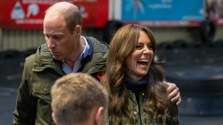 Prince William with hand on Kate Middleton's shoulder