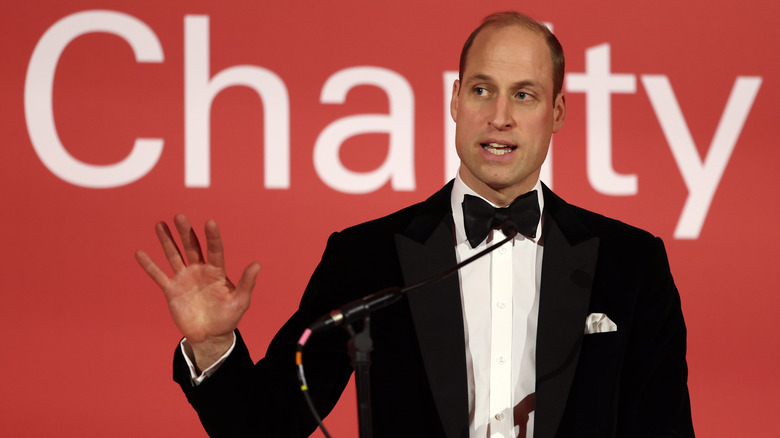 Prince William raising hand