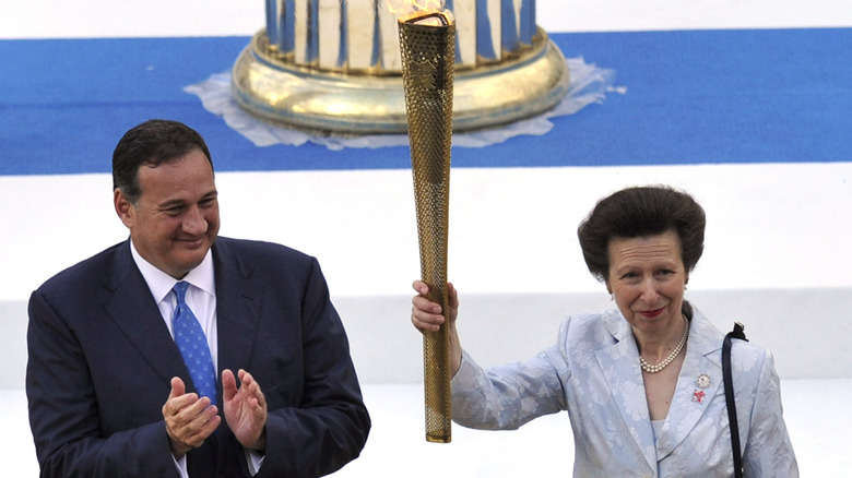 Princess Anne hoisting the Olympic flame