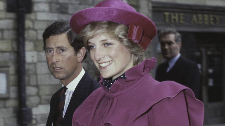 Prince Charles walking with a smiling Princess Diana 