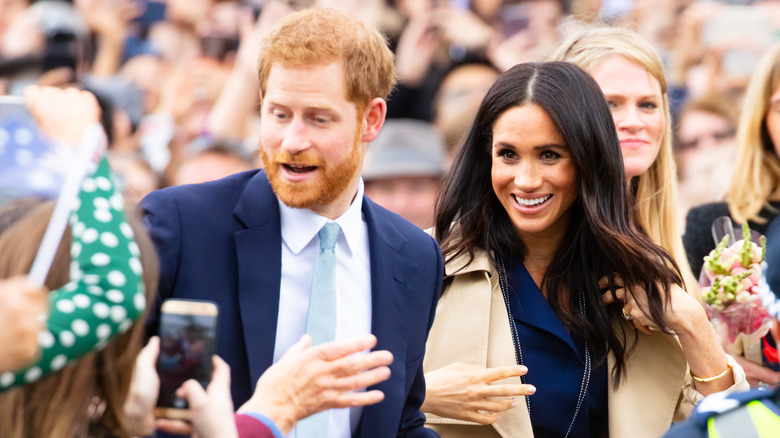 Prince Harry and Meghan walking in crowd