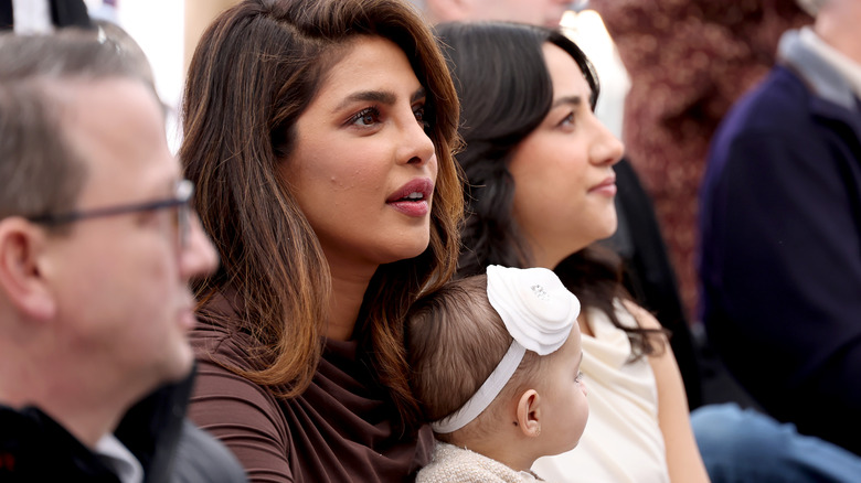 Priyanka Chopra and Malti Marie Chopra Jonas sitting in the audience