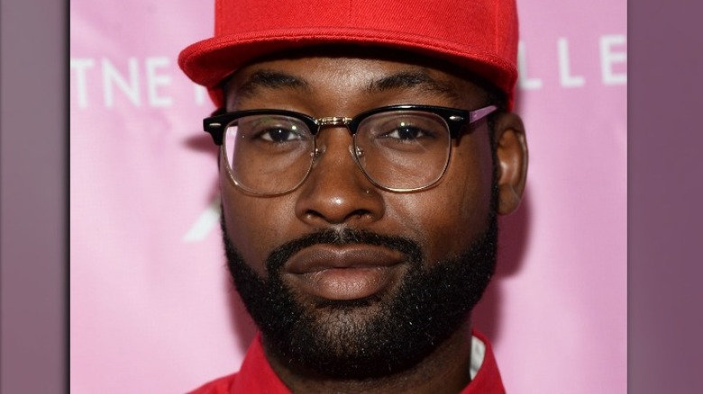 Mychael Knight smiling in red cap