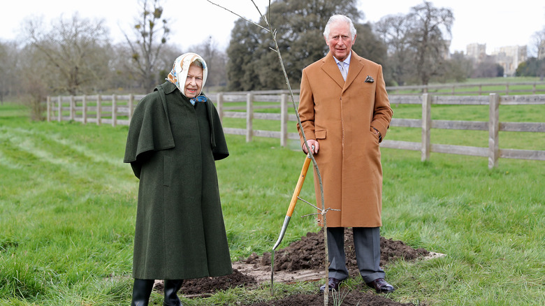 Queen Elizabeth and Prince Charles planting a tree