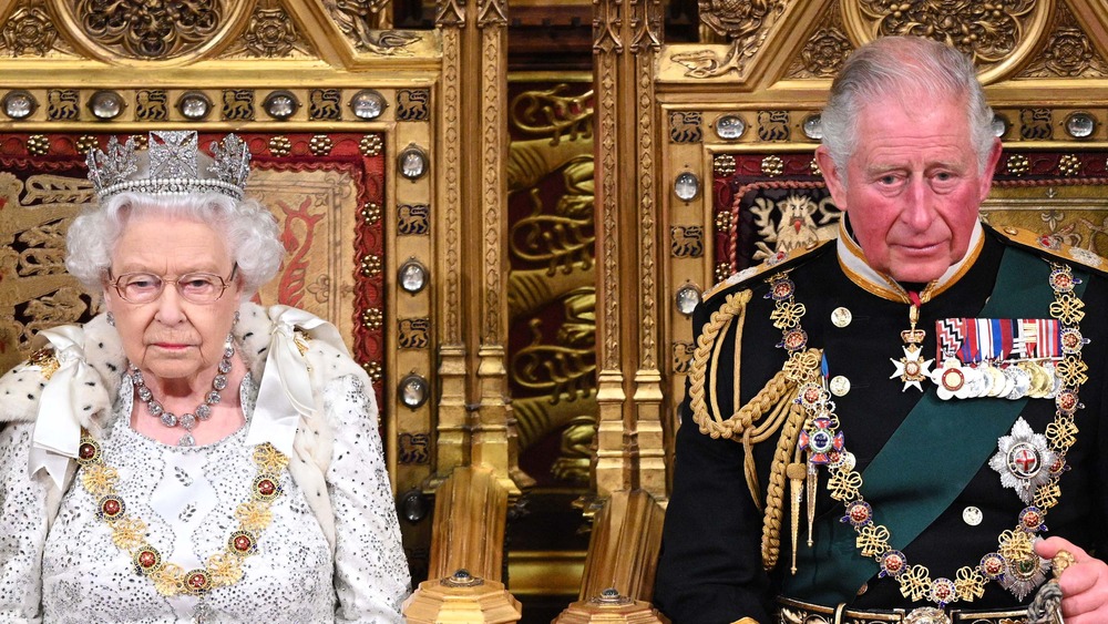 Queen Elizabeth II and Prince Charles sitting on thrones