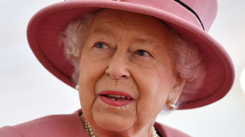 Queen Elizabeth wearing a pink hat