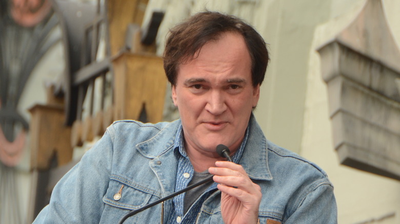 Quentin Tarantino speaking into microphone