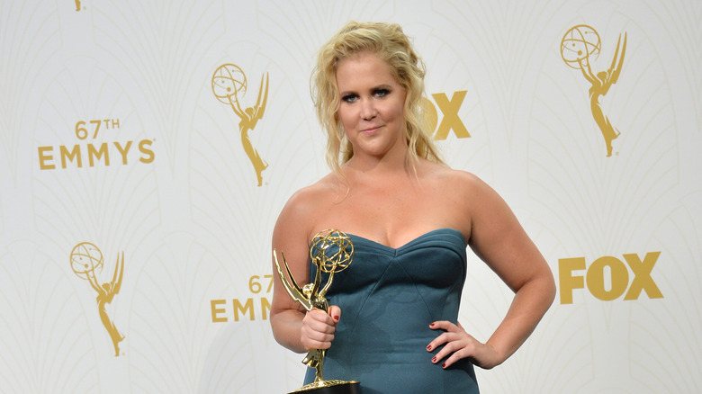 Amy Schumer holding an Emmy