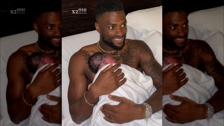 Van Jefferson holding his newborn