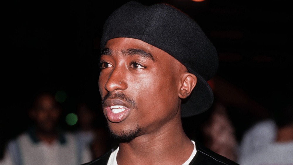 Tupac wearing hat backwards
