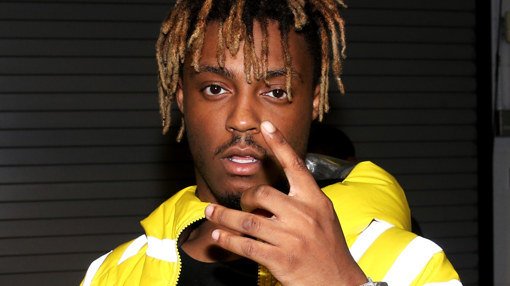 Juice Wrld making a hand gesture