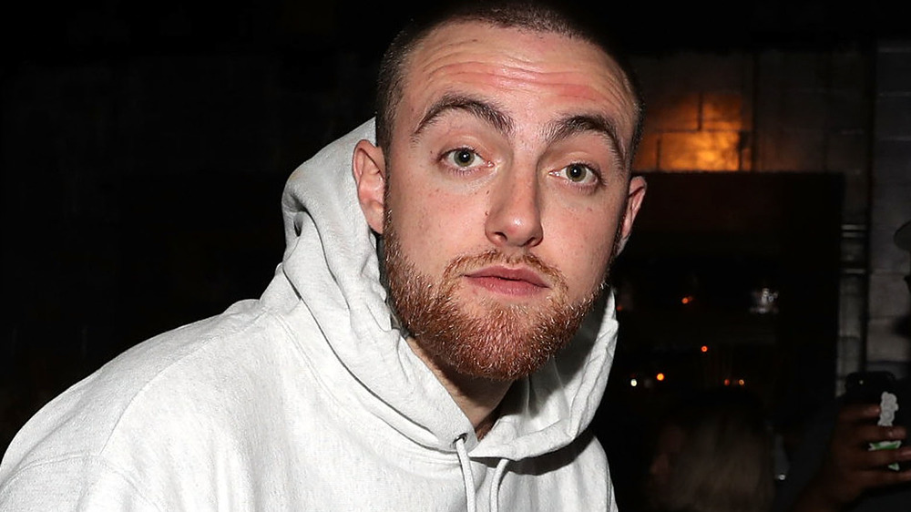 Mac Miller wearing a hooded sweatshirt