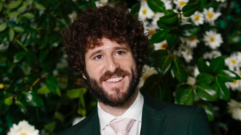 Lil Dicky in green suit, smiling