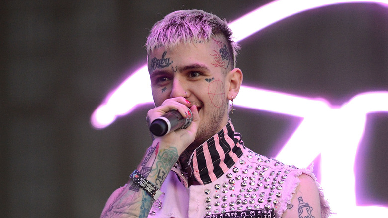 LIl Peep with purple hair holding microphone