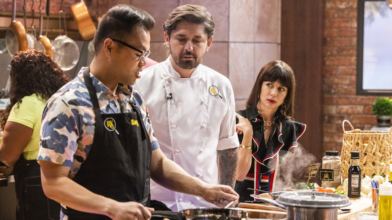 Natasha Leggero watching contestant Ludo Lefebvre looking down