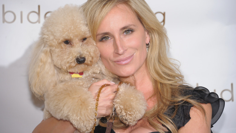 Sonja Morgan posing with a puppy