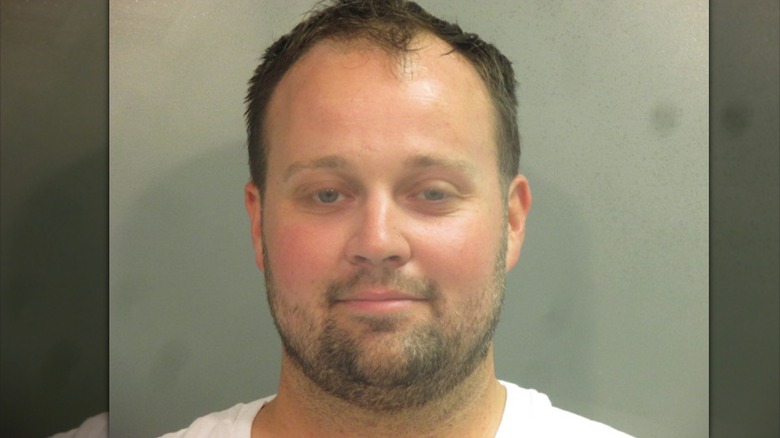 Josh Duggar smiling in mug shot