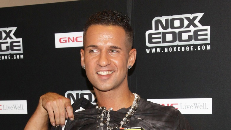 Mike 'The Situation' Sorrentino posing with his hand by his shirt