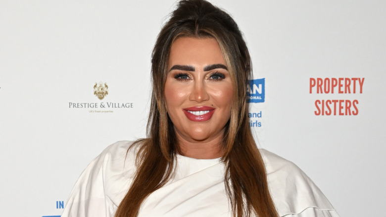 Lauren Goodger smiling for photographers in London in March 2024