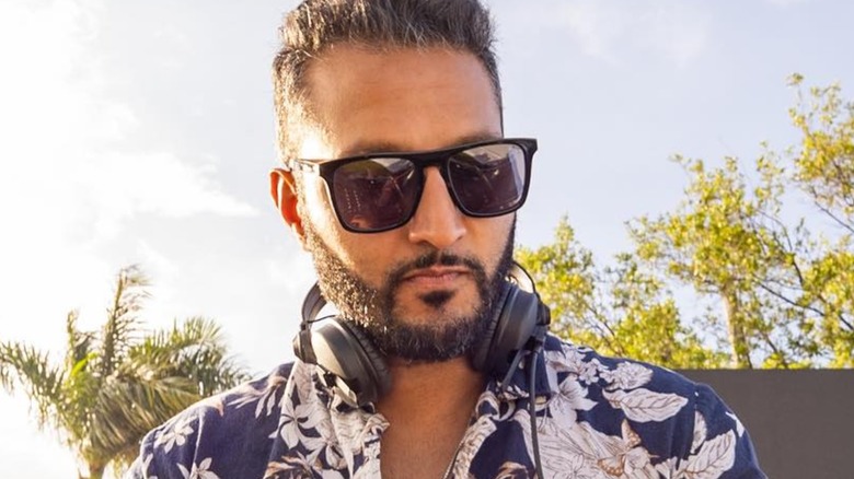 Shake Chatterjee DJing in Miami in July 2023 while wearing sunglasses