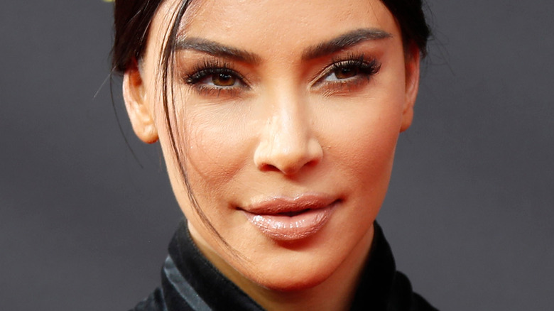 Kim Kardashian smirks