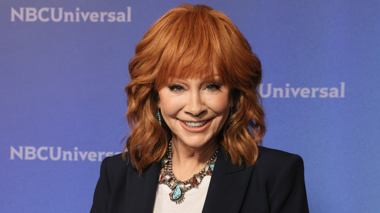 Reba McEntire smiling and wearing turquoise jewelry