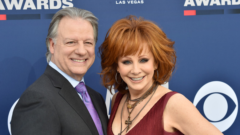 Anthony Lasuzzo and Reba McEntire pose together in 2019