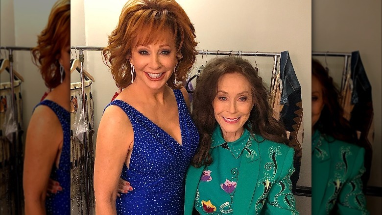 Reba and Loretta Lynn posing