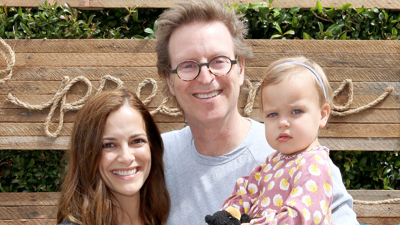 Rebecca Budig posing with husband Michael Benson and daughter Charlotte