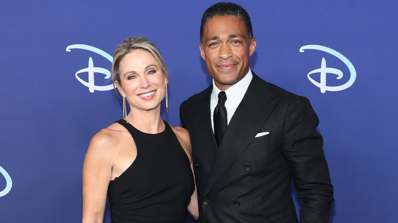 Amy Robach and TJ Holmes pose on a red carpet